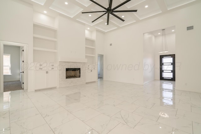 2909 Daytona Ave, Amarillo, TX 79118 - unfurnished living room featuring a high ceiling, built in features, beam ceiling, coffered ceiling, and a tile fireplace