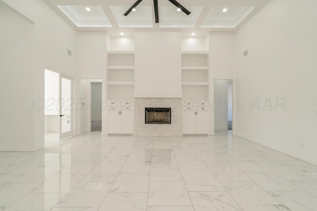 2909 Daytona Ave, Amarillo, TX 79118 - unfurnished living room featuring ceiling fan, a tiled fireplace, built in features, recessed lighting, and a high ceiling
