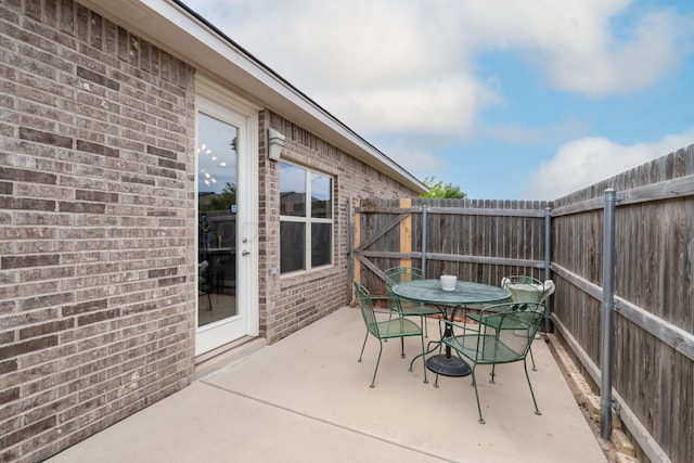 view of patio featuring a fenced backyard and outdoor dining area