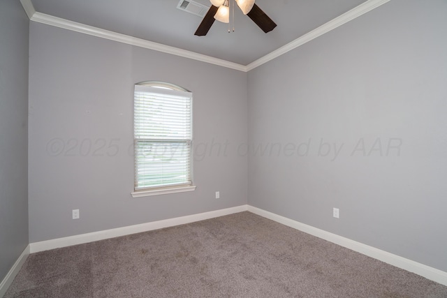 carpeted empty room featuring crown molding, ceiling fan, visible vents, and baseboards