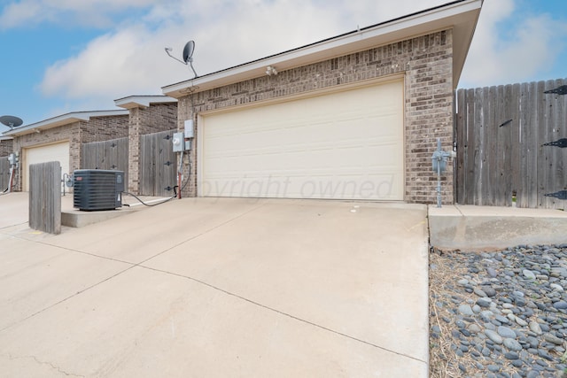 garage featuring central AC and fence