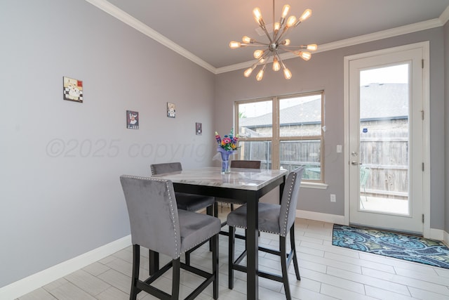 dining space featuring crown molding, baseboards, a chandelier, and light wood-type flooring