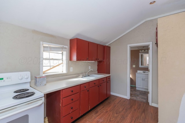 kitchen with white electric range oven, red cabinetry, vaulted ceiling, and a sink