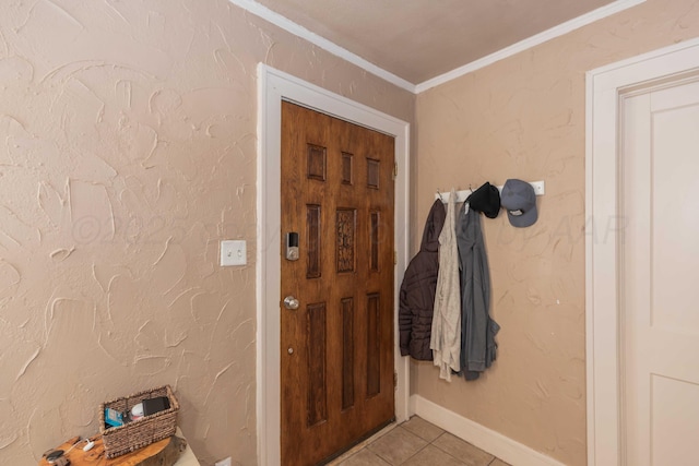 interior space with ornamental molding, a textured wall, baseboards, and light tile patterned floors