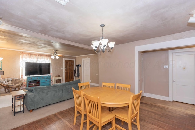 dining room featuring baseboards, wood finished floors, and ceiling fan with notable chandelier