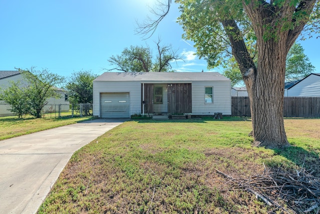 ranch-style home with a garage and a front lawn