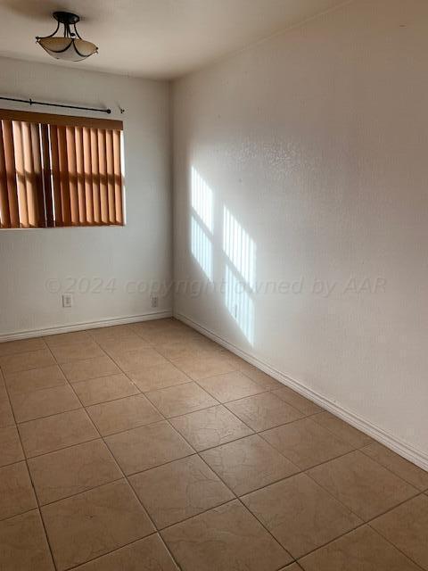 3610 S Harrison St, Amarillo, TX 79110 - unfurnished room with light tile patterned floors and baseboards