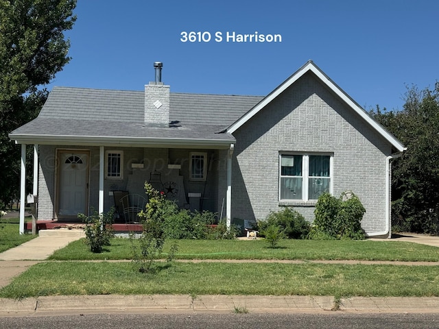 view of front of home with a porch and a front lawn