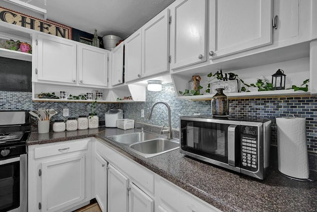 kitchen featuring open shelves, a sink, white cabinets, and stainless steel appliances