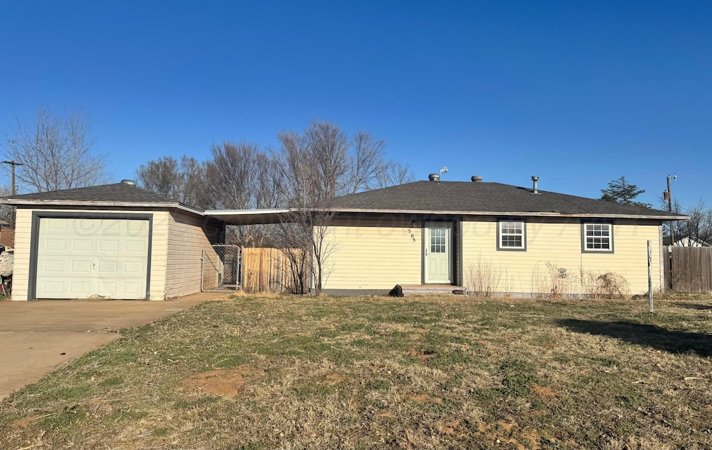 single story home featuring an attached garage, driveway, a front yard, and fence