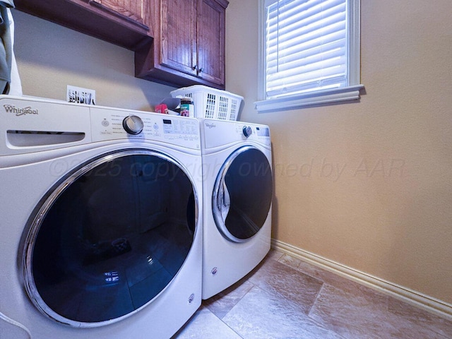 6004 Glenwood Dr, Amarillo, TX 79119 - clothes washing area featuring cabinet space, washing machine and clothes dryer, baseboards, and light stone finish flooring