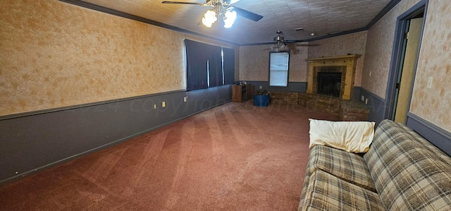 unfurnished living room with a fireplace, ceiling fan, crown molding, and carpet floors