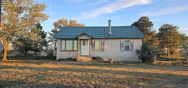 bungalow featuring a front lawn