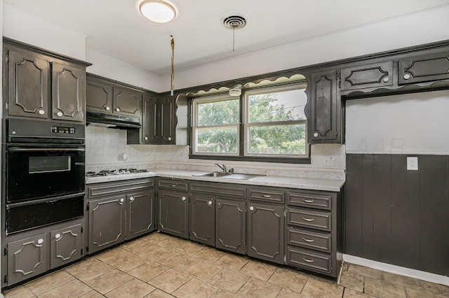 2902 Pryor St, Amarillo, TX 79103 - kitchen with oven, a warming drawer, under cabinet range hood, and light countertops