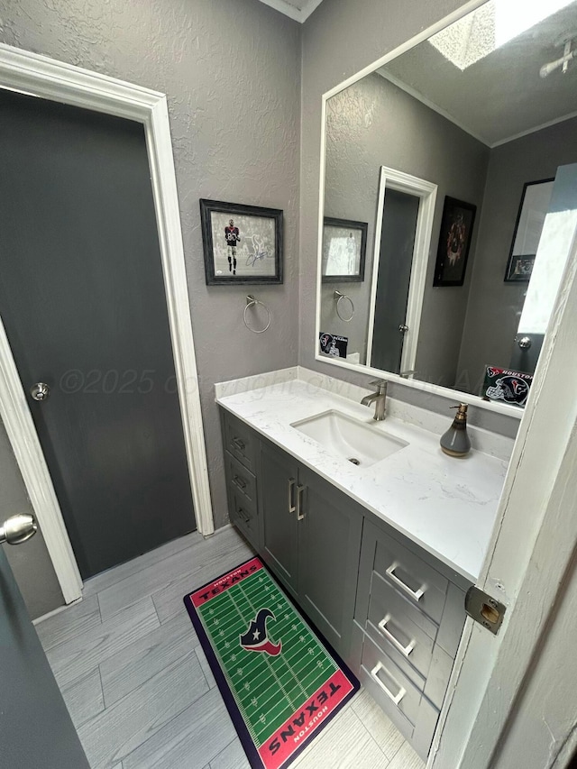 712 Groom Ave, Panhandle, TX 79068 - bathroom with vanity, a skylight, and a textured wall
