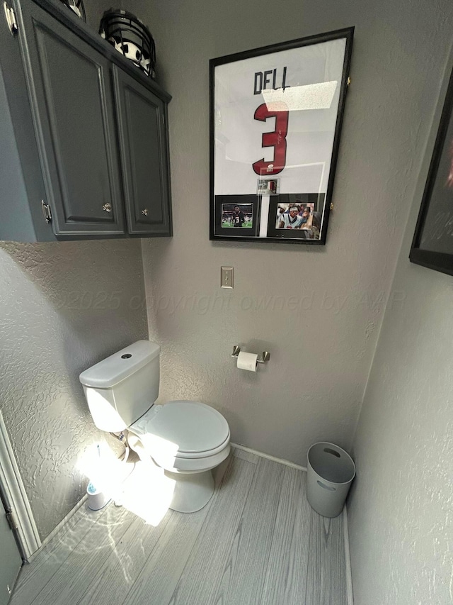 712 Groom Ave, Panhandle, TX 79068 - bathroom with toilet and wood finished floors