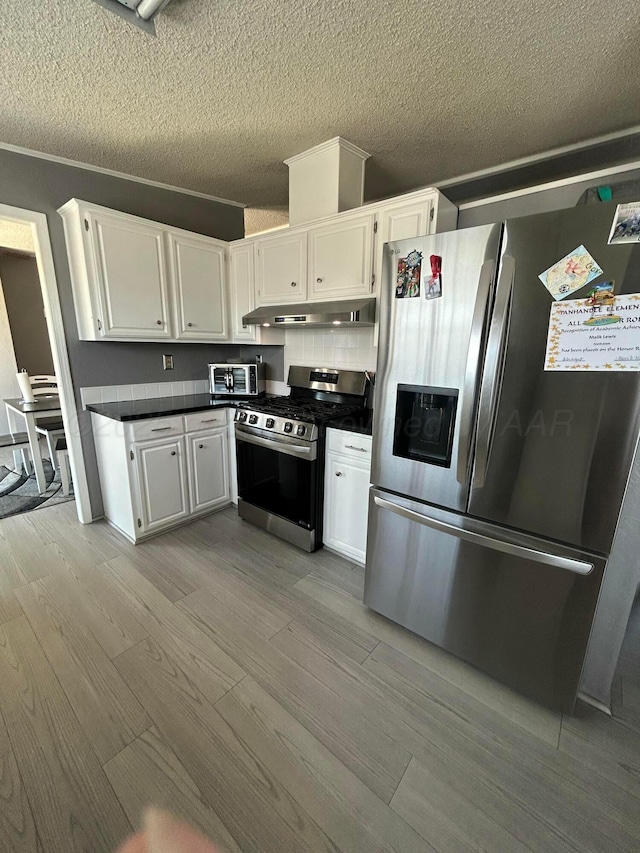 712 Groom Ave, Panhandle, TX 79068 - kitchen featuring appliances with stainless steel finishes, under cabinet range hood, light wood finished floors, white cabinetry, and a textured ceiling