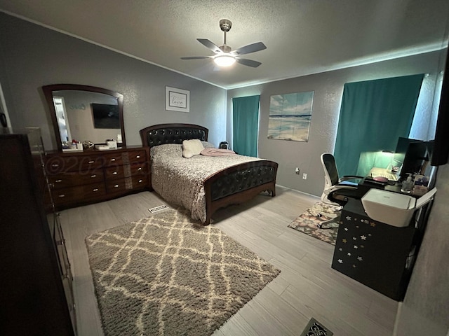 712 Groom Ave, Panhandle, TX 79068 - bedroom with a textured ceiling, crown molding, wood finished floors, a textured wall, and a desk