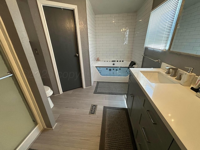 712 Groom Ave, Panhandle, TX 79068 - full bath with wood finished floors, a jetted tub, vanity, and a shower with door