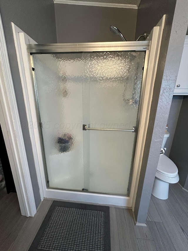 712 Groom Ave, Panhandle, TX 79068 - bathroom featuring wood finished floors and a shower stall