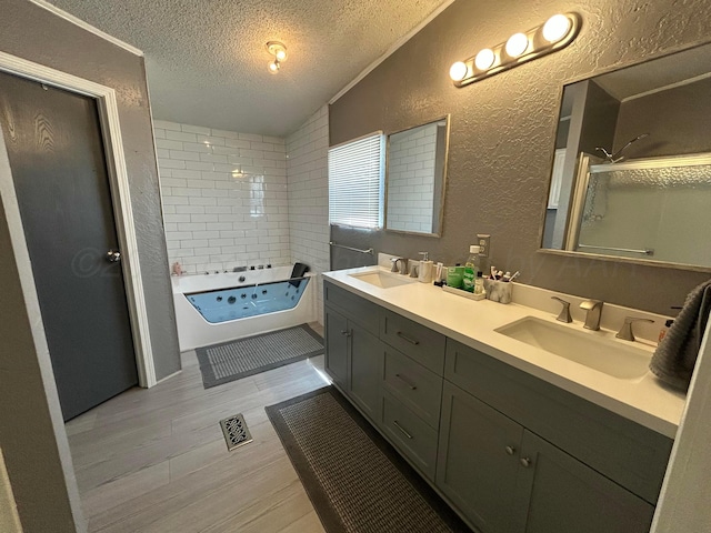 712 Groom Ave, Panhandle, TX 79068 - full bathroom with a textured wall, a textured ceiling, double vanity, a whirlpool tub, and wood finished floors