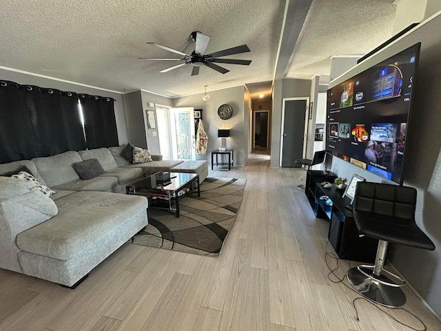 712 Groom Ave, Panhandle, TX 79068 - living room with a ceiling fan, light wood-style floors, and a textured ceiling