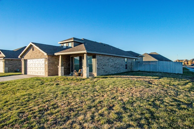 view of front of house with a front yard and a garage