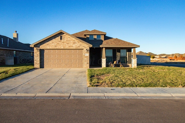 view of front of property with a garage and a front yard