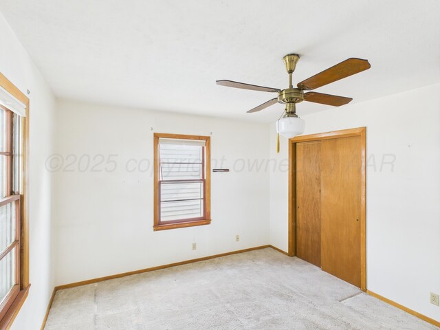 502 Spruce Ave, Dumas, TX 79029 - spare room with carpet, baseboards, and a ceiling fan