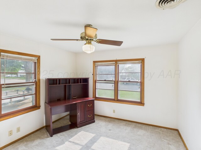 502 Spruce Ave, Dumas, TX 79029 - unfurnished office featuring baseboards, light colored carpet, and ceiling fan