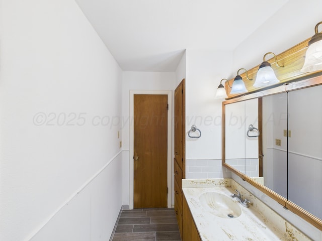 502 Spruce Ave, Dumas, TX 79029 - bathroom with vanity and wood finished floors