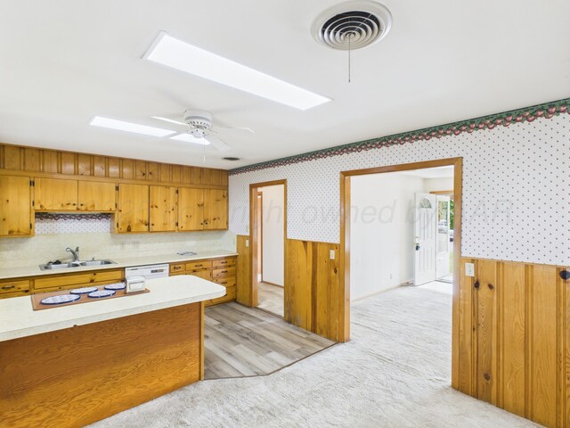 502 Spruce Ave, Dumas, TX 79029 - kitchen with a sink, light countertops, wallpapered walls, brown cabinetry, and white appliances