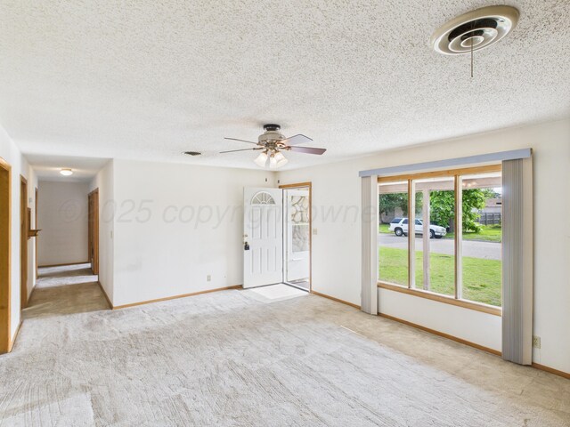 502 Spruce Ave, Dumas, TX 79029 - empty room featuring a ceiling fan, carpet, a textured ceiling, and baseboards
