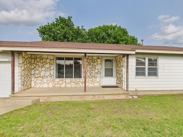 502 Spruce Ave, Dumas, TX 79029 - view of front of home with a porch, stone siding, a front yard, and an attached garage