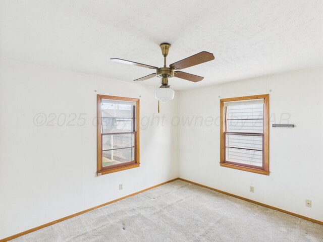 502 Spruce Ave, Dumas, TX 79029 - spare room with baseboards, light carpet, and ceiling fan