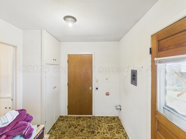 502 Spruce Ave, Dumas, TX 79029 - laundry room featuring carpet floors and baseboards