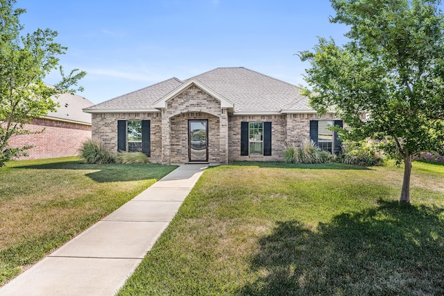 7907 Crestline Dr, Amarillo, TX 79119 - french country inspired facade featuring a front lawn, brick siding, and a shingled roof