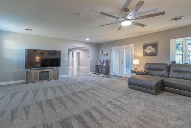 living room with french doors, carpet, a textured ceiling, and ceiling fan