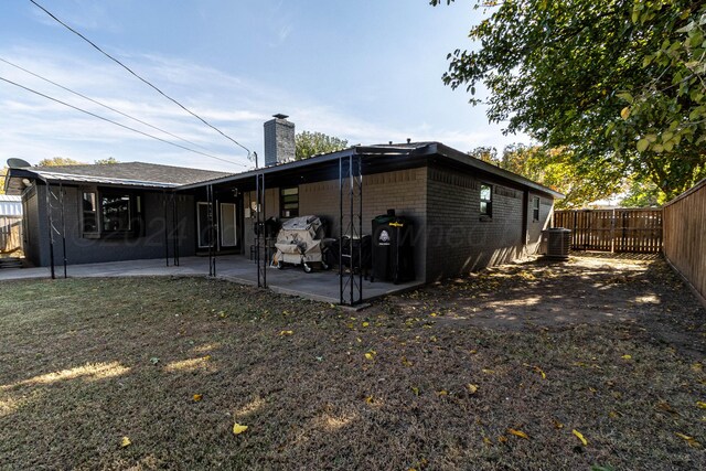 rear view of property featuring central AC and a patio