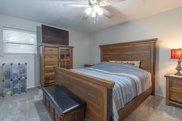 carpeted bedroom featuring a textured ceiling and ceiling fan