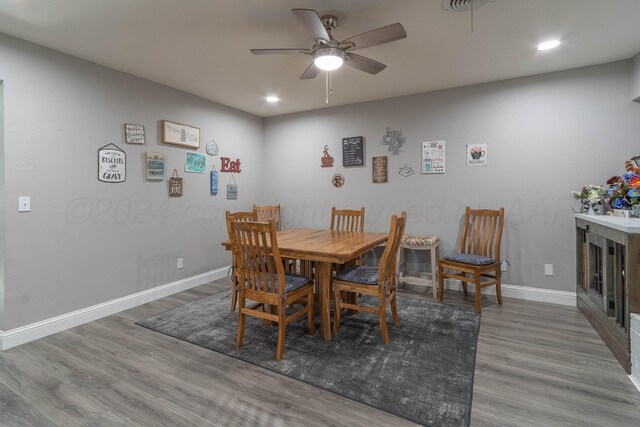 dining area with hardwood / wood-style flooring and ceiling fan