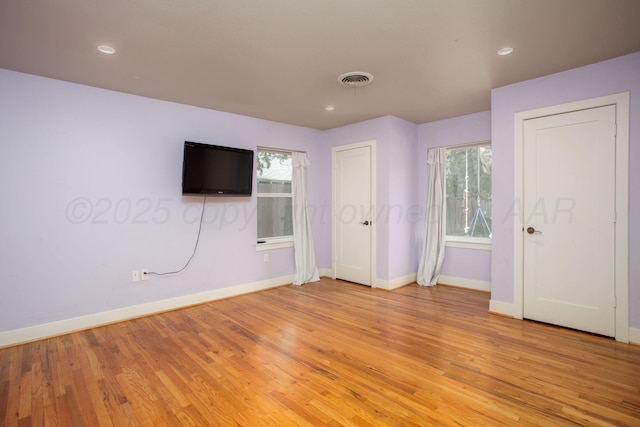1510 Crockett St, Amarillo, TX 79102 - unfurnished bedroom featuring light wood finished floors, multiple windows, and recessed lighting