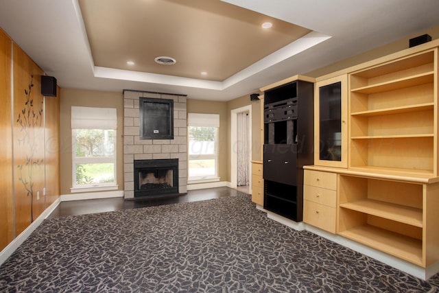 1510 Crockett St, Amarillo, TX 79102 - unfurnished living room featuring a tray ceiling, a large fireplace, healthy amount of natural light, and recessed lighting