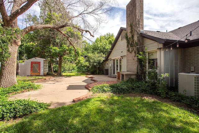 1510 Crockett St, Amarillo, TX 79102 - view of grassy yard with a patio area and a shed