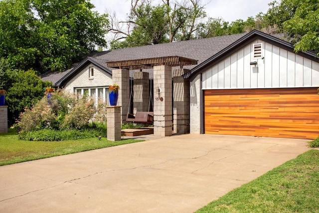 1510 Crockett St, Amarillo, TX 79102 - view of front of home featuring board and batten siding, concrete driveway, a garage, and a shingled roof