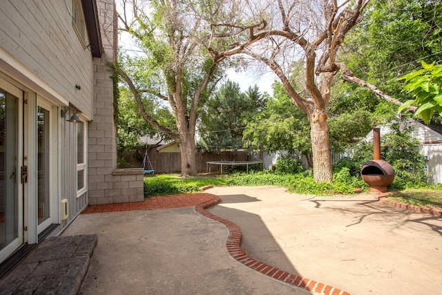 1510 Crockett St, Amarillo, TX 79102 - fenced backyard with a trampoline and a patio