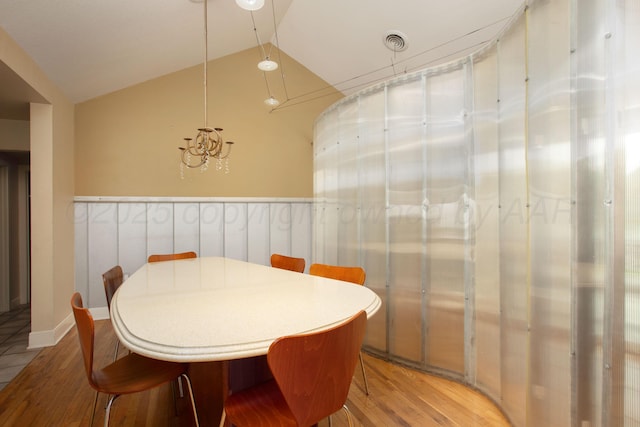 1510 Crockett St, Amarillo, TX 79102 - dining room featuring wood finished floors, vaulted ceiling, and a chandelier