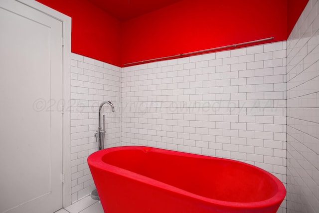 1510 Crockett St, Amarillo, TX 79102 - bathroom featuring tile walls, a soaking tub, and tile patterned flooring