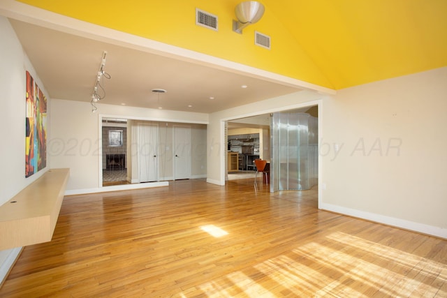 1510 Crockett St, Amarillo, TX 79102 - unfurnished living room featuring light wood-type flooring and lofted ceiling