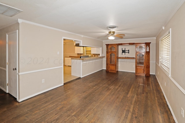 unfurnished living room with crown molding, dark wood-type flooring, and ceiling fan